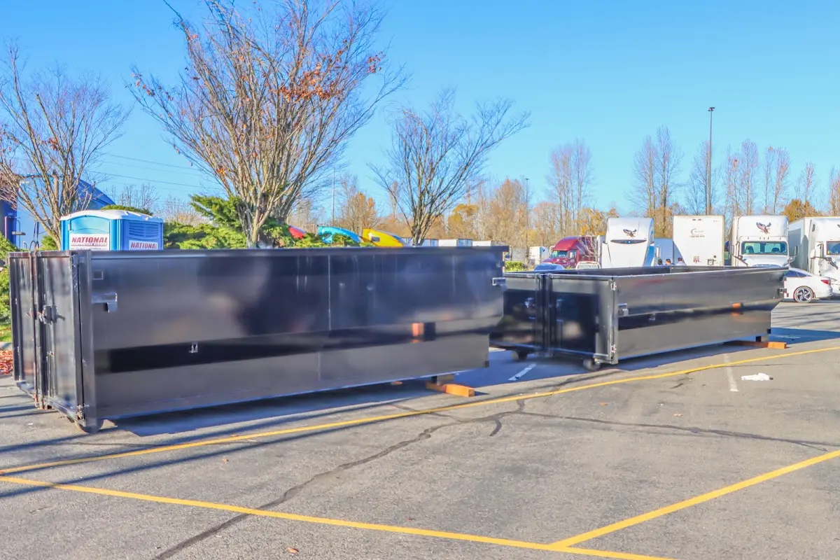 Professional dumpster rental service with roll-off container on residential driveway in Conway